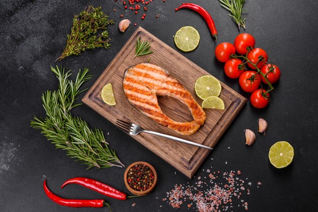 Fresh cooked delicious salmon steak with spices and herbs baked on a grill. Healthy seafood food