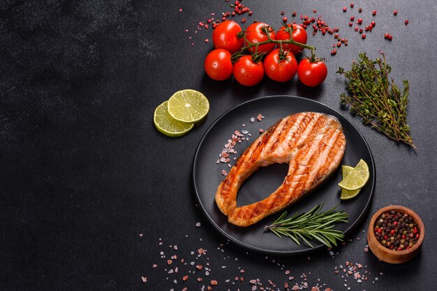 Fresh cooked delicious salmon steak with spices and herbs baked on a grill