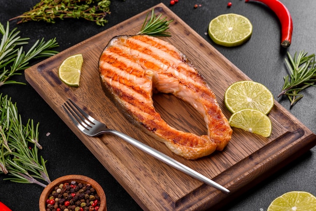 Fresh cooked delicious salmon steak with spices and herbs baked on a grill