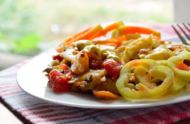 Fresh cooked vegetables and fried omelet closeup