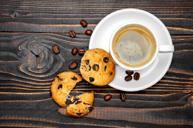 Fresh cookies and coffee on wooden background