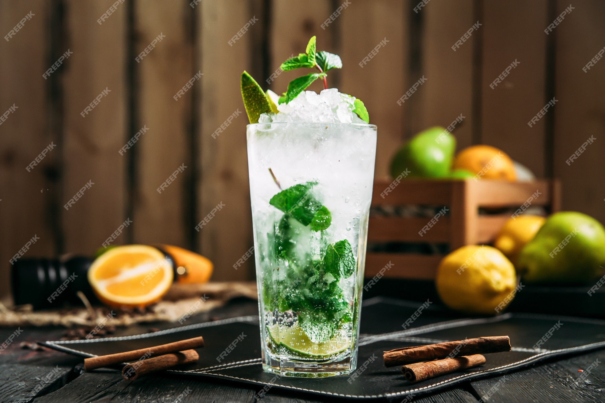 Mojito cocktail with lime and mint in highball glass on a grey stone  background Stock Photo by annapustynnikova