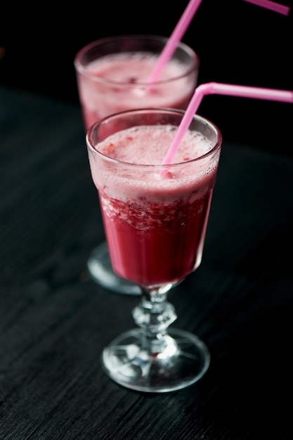 Fresh cool smoothie in a glass with a stem Delicious and healthy BreakfastOf cherries and strawberries