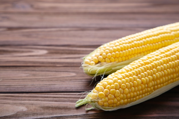 Fresh corn on a brown wooden table