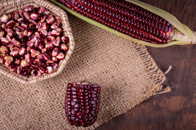 Fresh corn on cobs on rustic wooden table, closeup