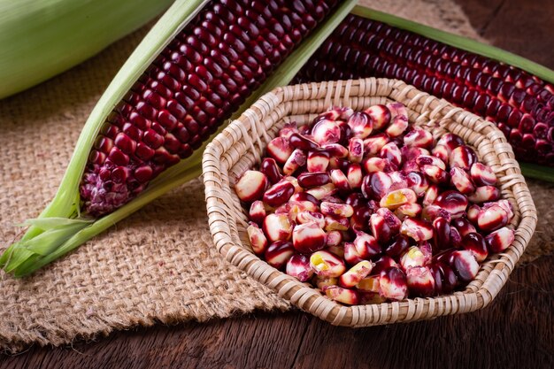 fresh corn on cobs on rustic wooden table, closeup
