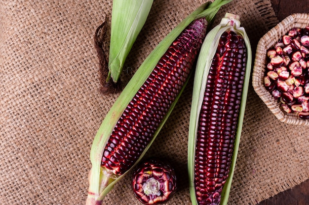 Fresh corn on cobs on rustic wooden table, closeup