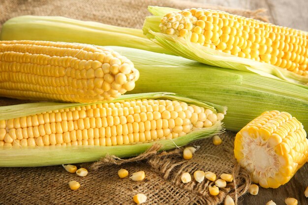 Fresh corn cobs on table