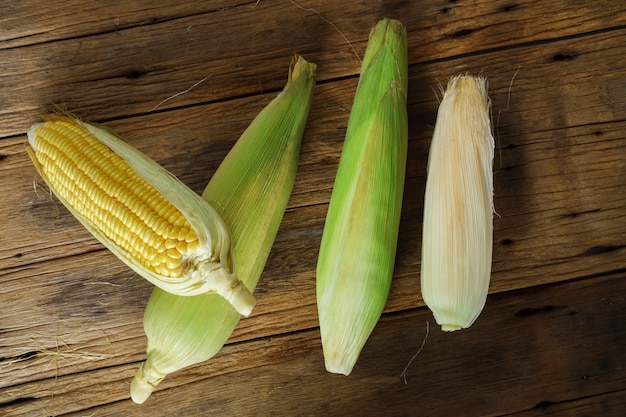 Fresh corn on the old wooden background, Top view