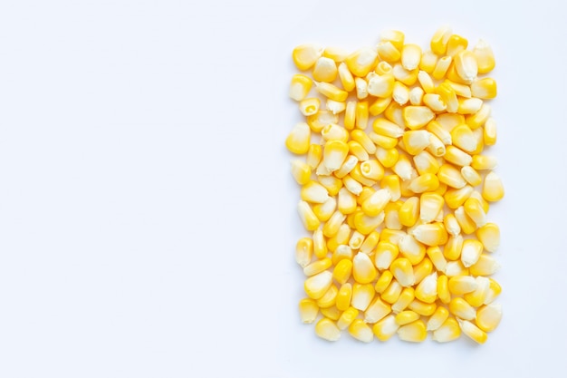 Fresh corn seeds on a white background.