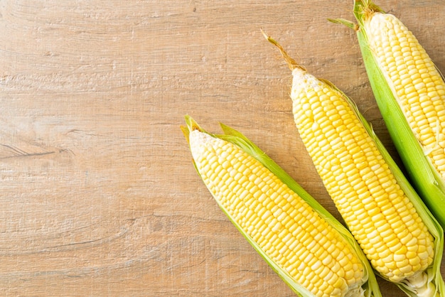 fresh corn on wood background with copy space