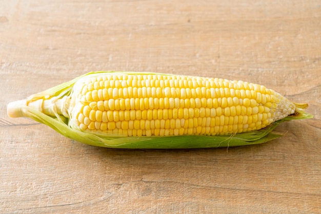 Fresh corn on wood background