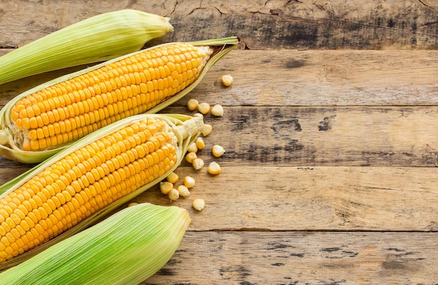 Fresh corn on wooden table background