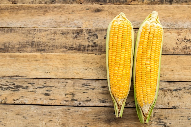 Fresh corn on wooden table background