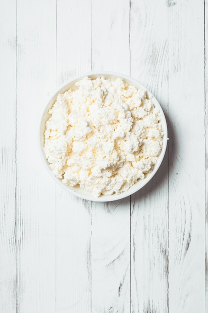 Fresh cottage cheese in bowl on the table