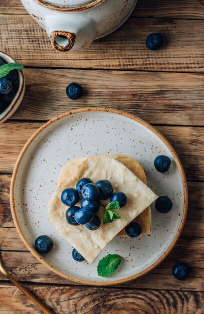 Fresh cottage cheese casserole on white plate on white tile background