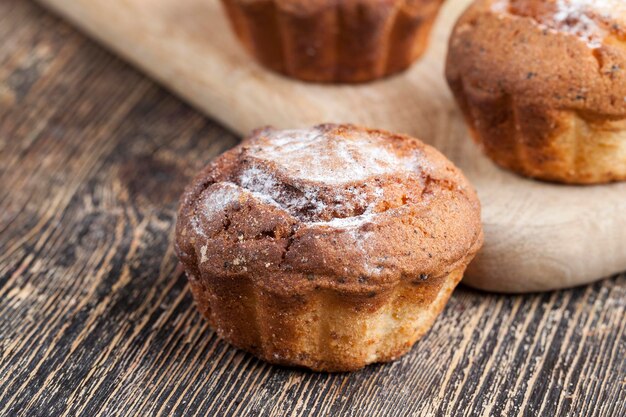 fresh cottage cheese cupcake on a wooden table, delicious soft homemade cupcake for dessert preparation