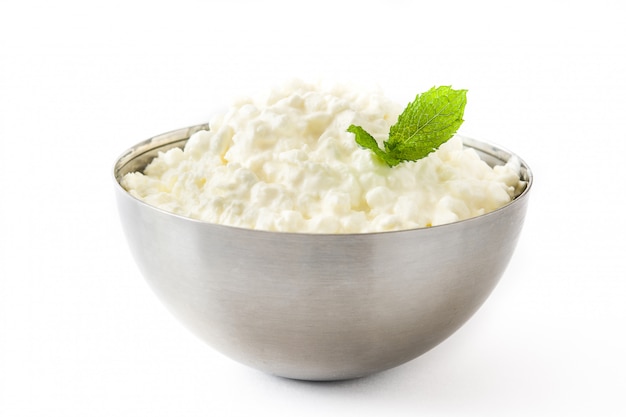 Fresh cottage cheese in a metal bowl isolated on white