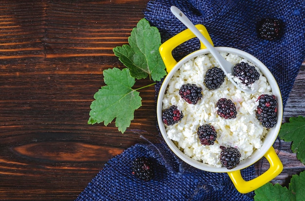 Fresh cottage cheese with fresh blackberries in a bowl