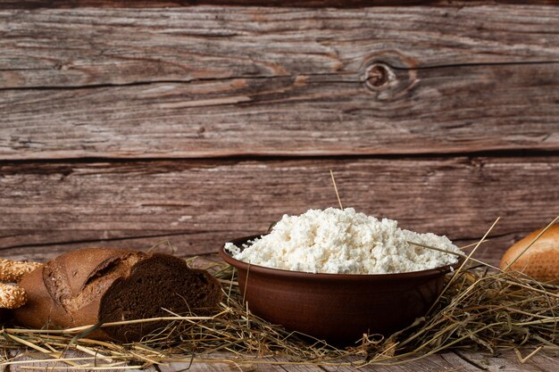 Fresh cottage cheese in a wooden bowl with a spoon