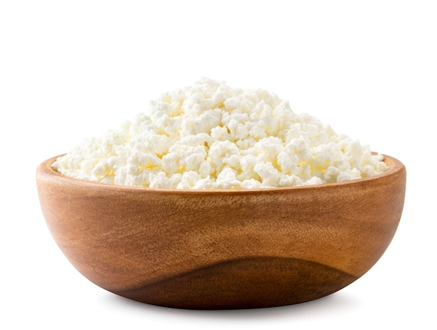 Fresh cottage cheese in a wooden plate close-up  Isolated