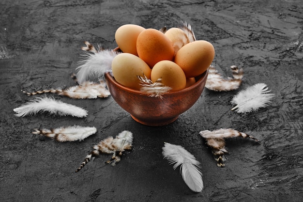 Fresh country eggs in clay bowl