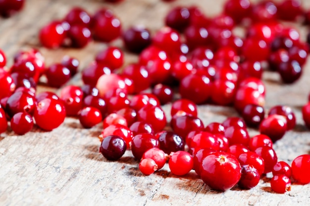 Fresh cranberry on old wooden table selective focus