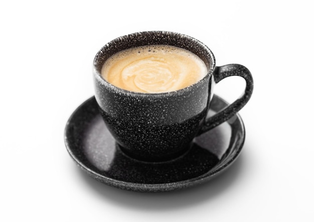 Fresh creamy black coffee in black cup with saucer on white background