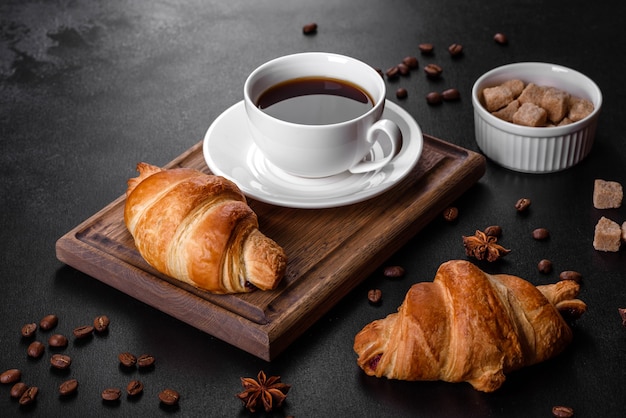 Fresh crisp delicious French croissant with a cup of fragrant coffee. Invigorating breakfast