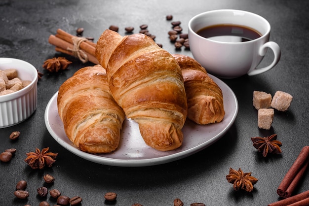 Fresh crisp delicious French croissant with a cup of fragrant coffee. Invigorating breakfast