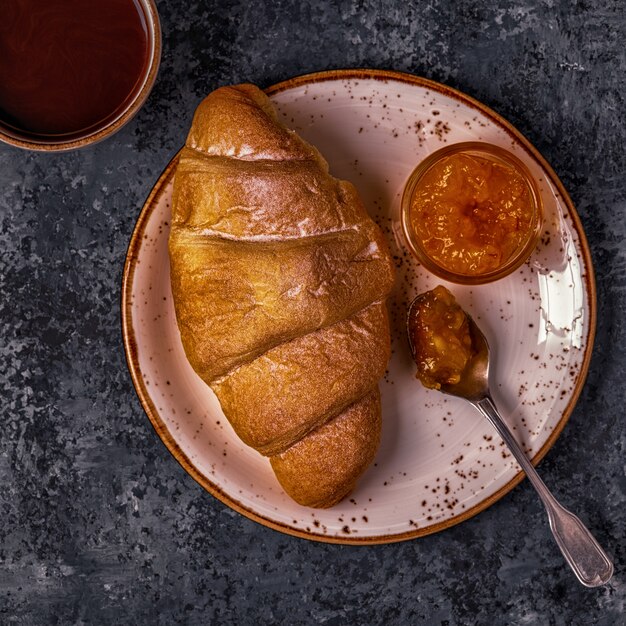 Fresh croissant on a dark background