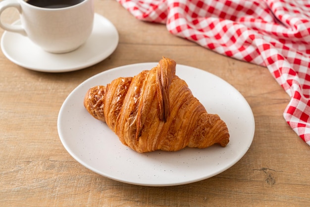 Fresh croissant on white plate