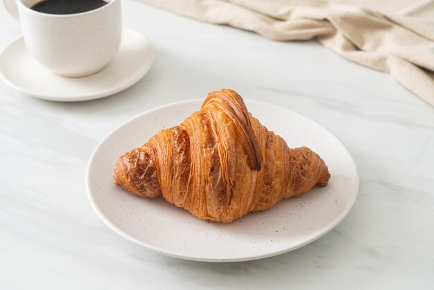 Fresh croissant on white plate