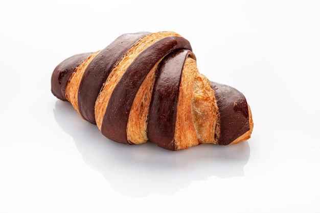 Fresh croissant with chocolate on a white background