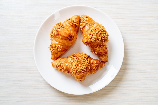 fresh croissant with peanut on plate