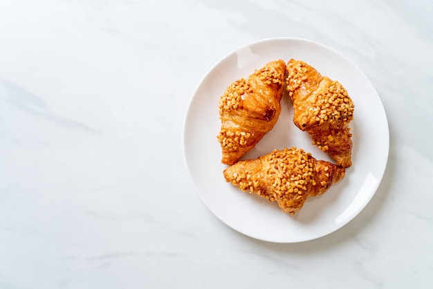 fresh croissant with peanut on plate