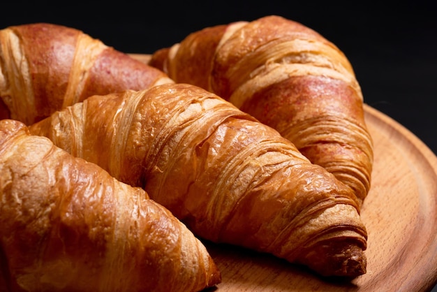 Fresh croissants on a cutting board closeup french cuisine concept