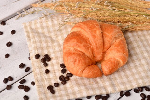 Fresh Croissants on rustic wooden background