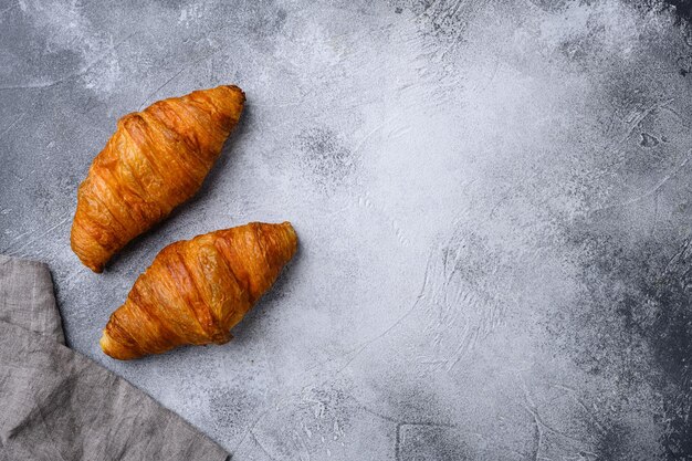 Fresh croissants on table set on gray stone table background top view flat lay with copy space for text