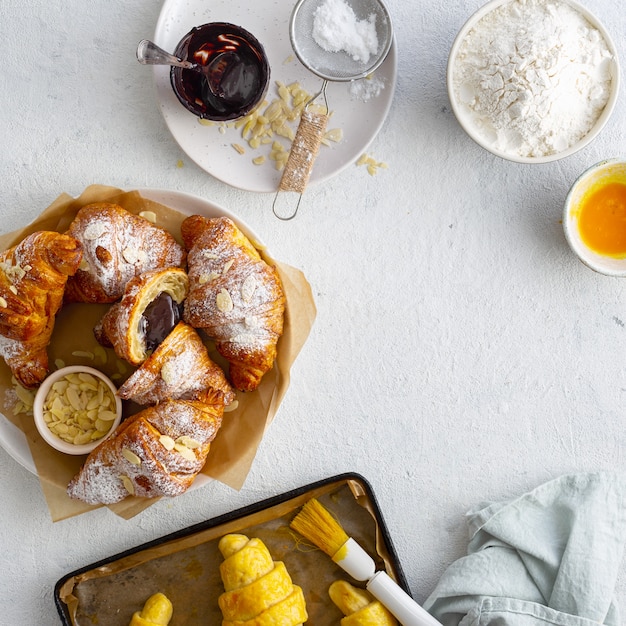 Photo fresh croissants with chocolate on a white background top view