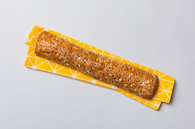 Fresh crunchy french baguette on colored table Top view Bakery products