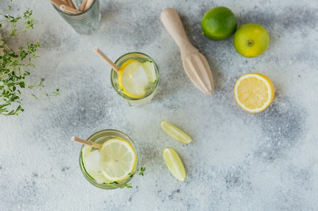 Fresh cucumber cocktail in a glass. summer cocktail with cucumber, lime, thyme and ice cubes on wooden table