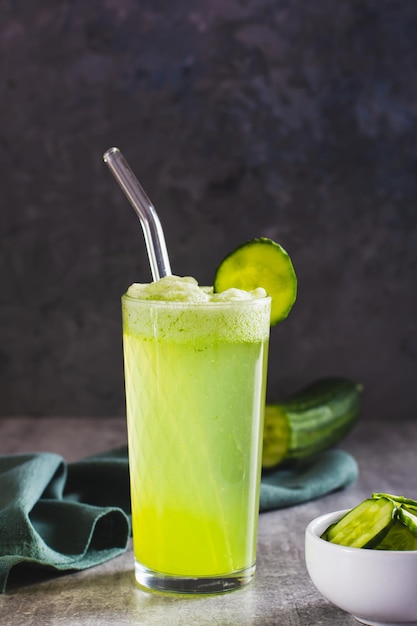 Fresh cucumber lemonade in a glass on the table vertical view