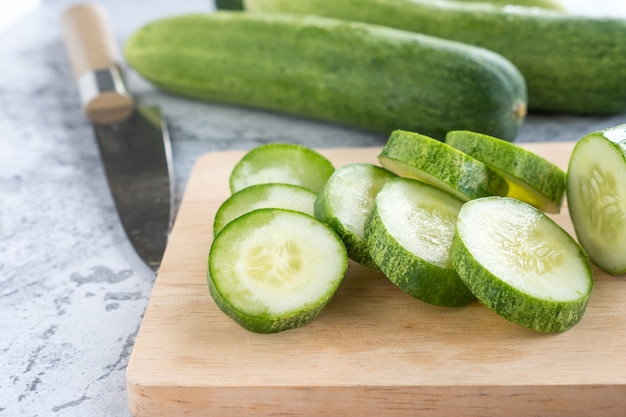 Fresh cucumber slices on a cutting board