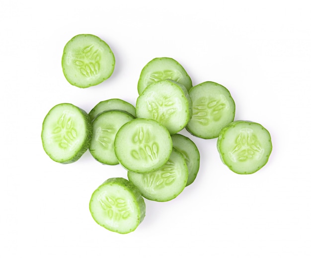 Fresh cucumber slices on white wall.