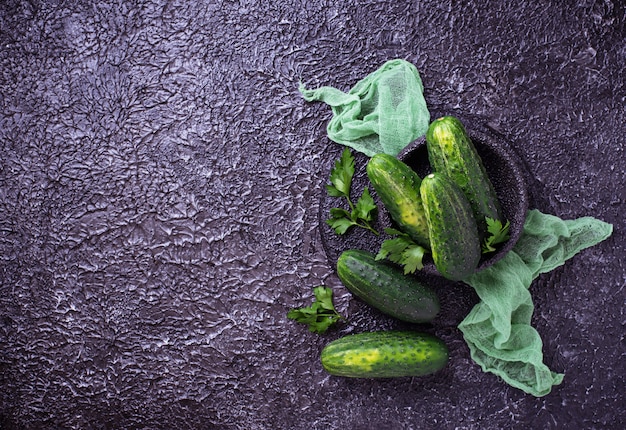 Fresh cucumbers on concrete background