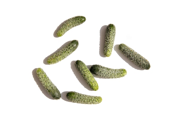 Fresh cucumbers on a white background Top view flat lay