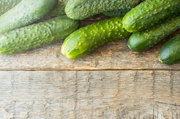 Fresh cucumbers on a wooden table. Rendered image, Copy space.