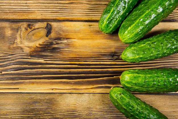 Fresh cucumbers on wooden table. Top view