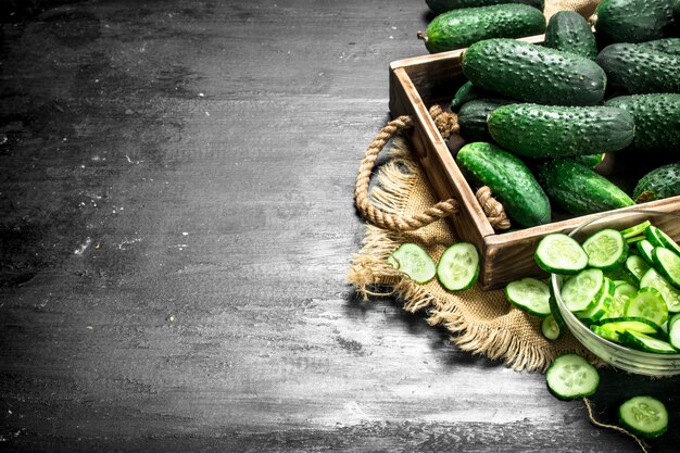 Fresh cucumbers in a wooden tray.